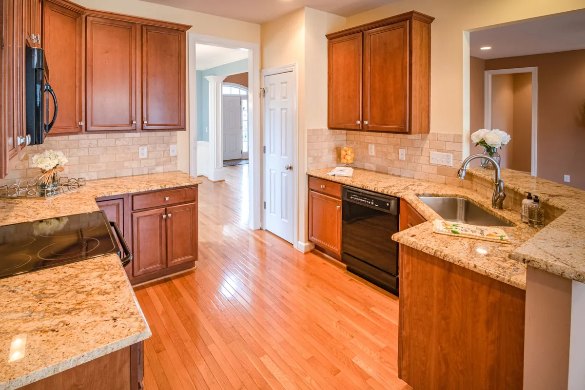A kitchen with wood cabinets and granite counters