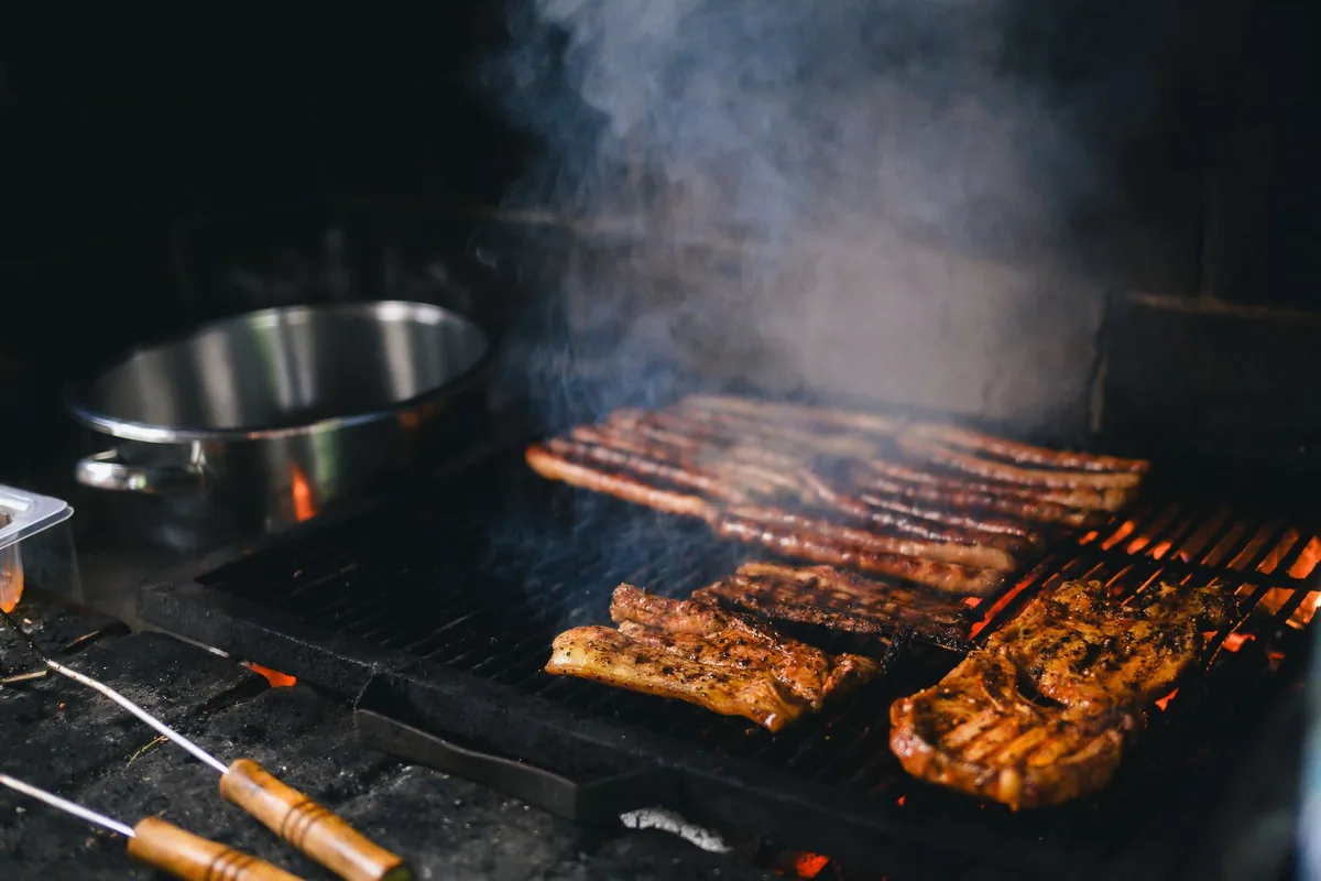 A clean stainless steel grill grate on an outdoor barbecue in daylight