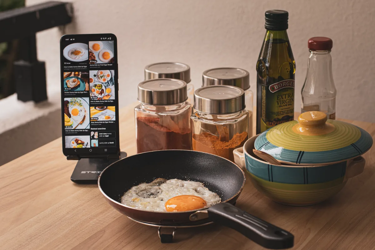 A clear bottle of golden cooking oil on a light kitchen worktop