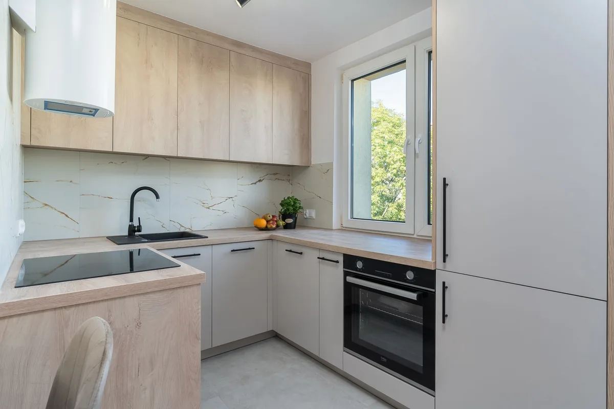 A compact kitchen with a single sink set into a short run of light countertop