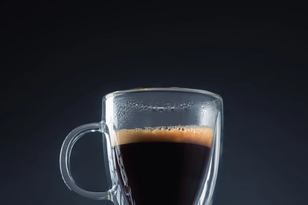 A double-walled glass of black coffee