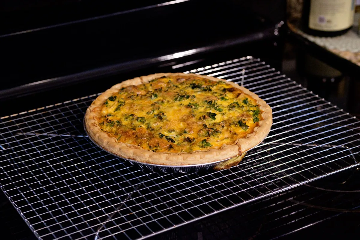A freshly baked pie cooling on a wire rack on a kitchen worktop