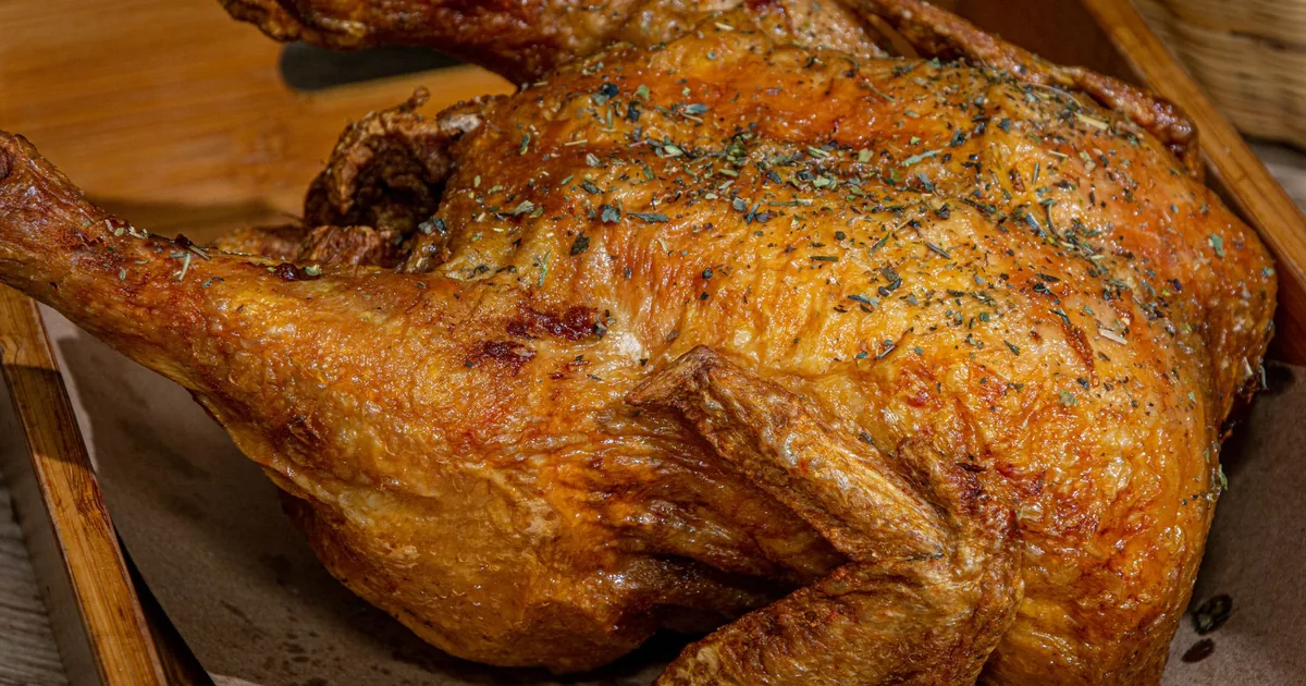 A golden roast chicken on a board