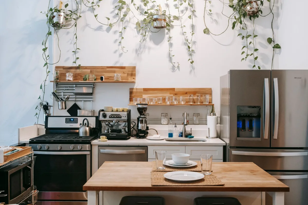 A group of stainless steel saucepans and pots with lids arranged on a bright kitchen counter
