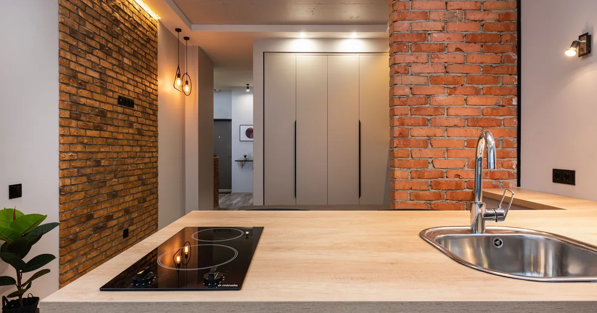 A kitchen island with a flush induction cooktop
