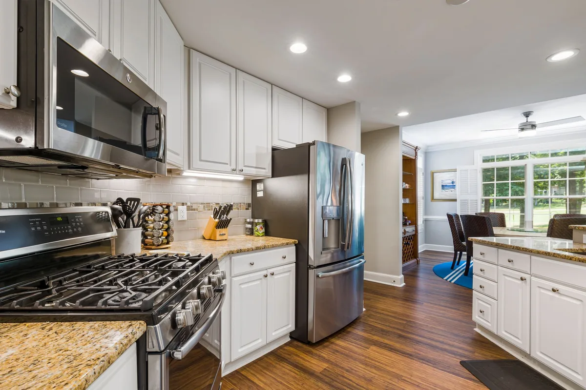 A kitchen with a microwave mounted above a gas range