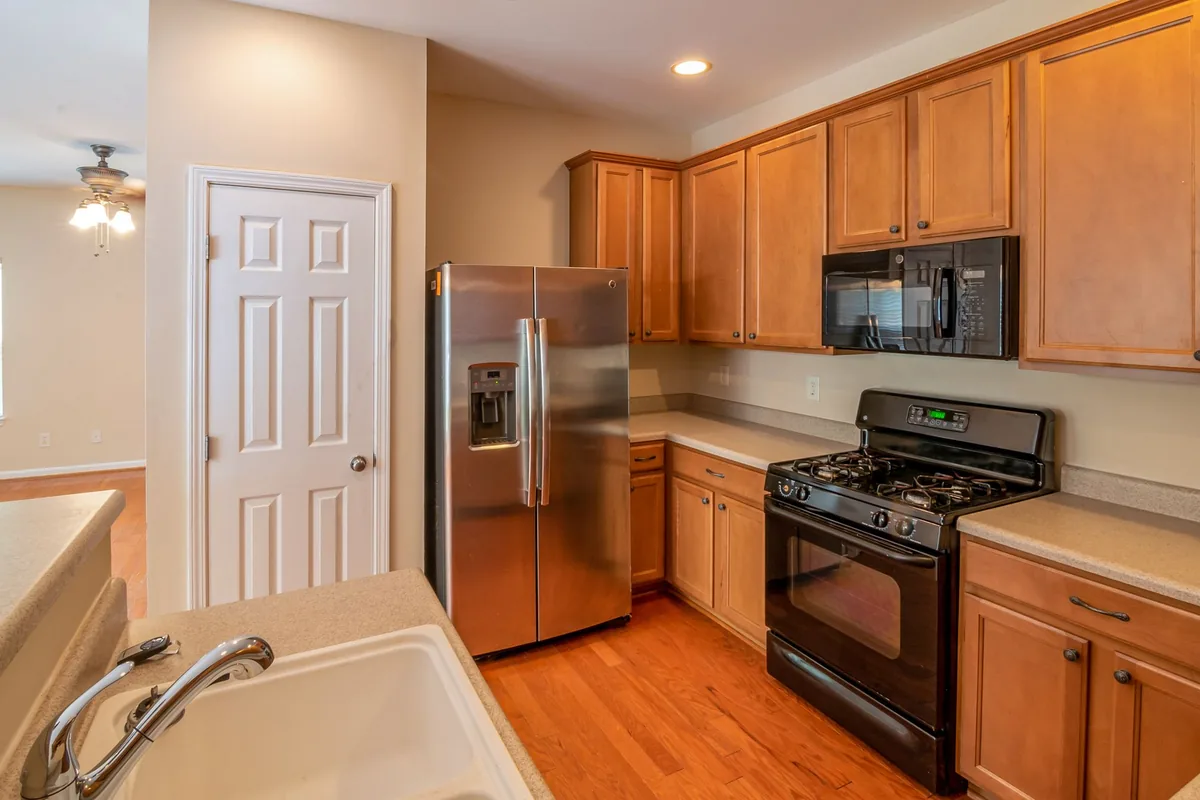 A kitchen with wood cabinets and stainless appliances