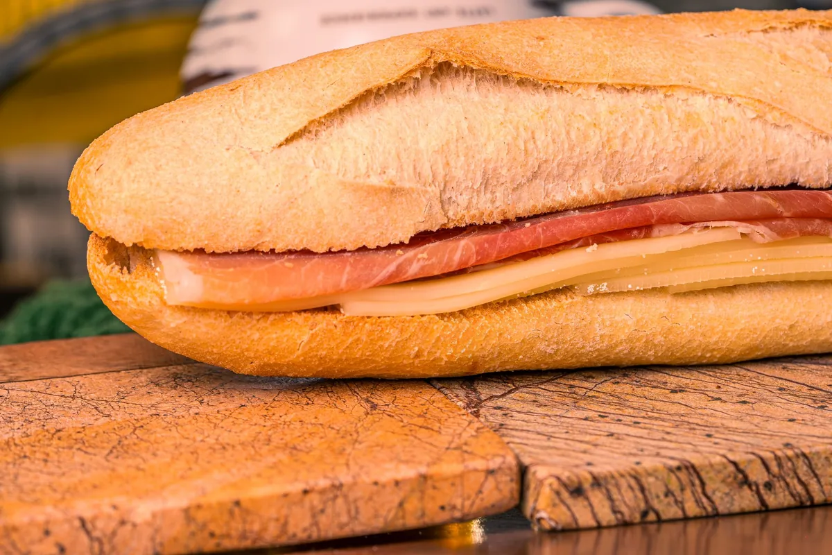 A long sandwich roll filled with ham and cheese