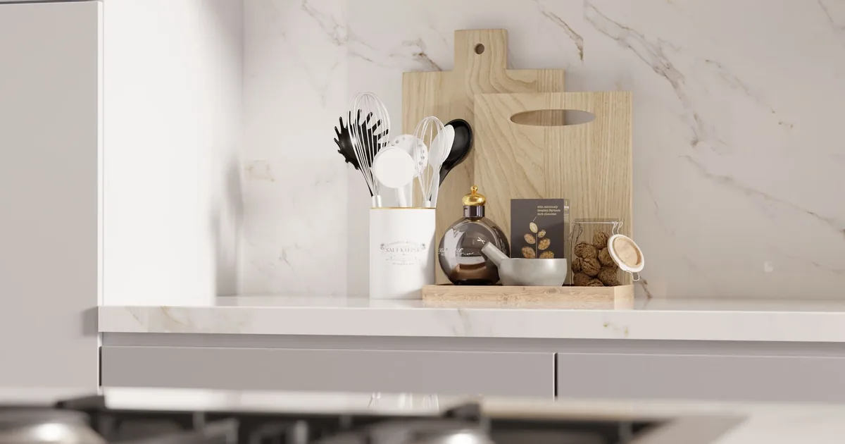 A marble counter with a utensil crock and cutting boards