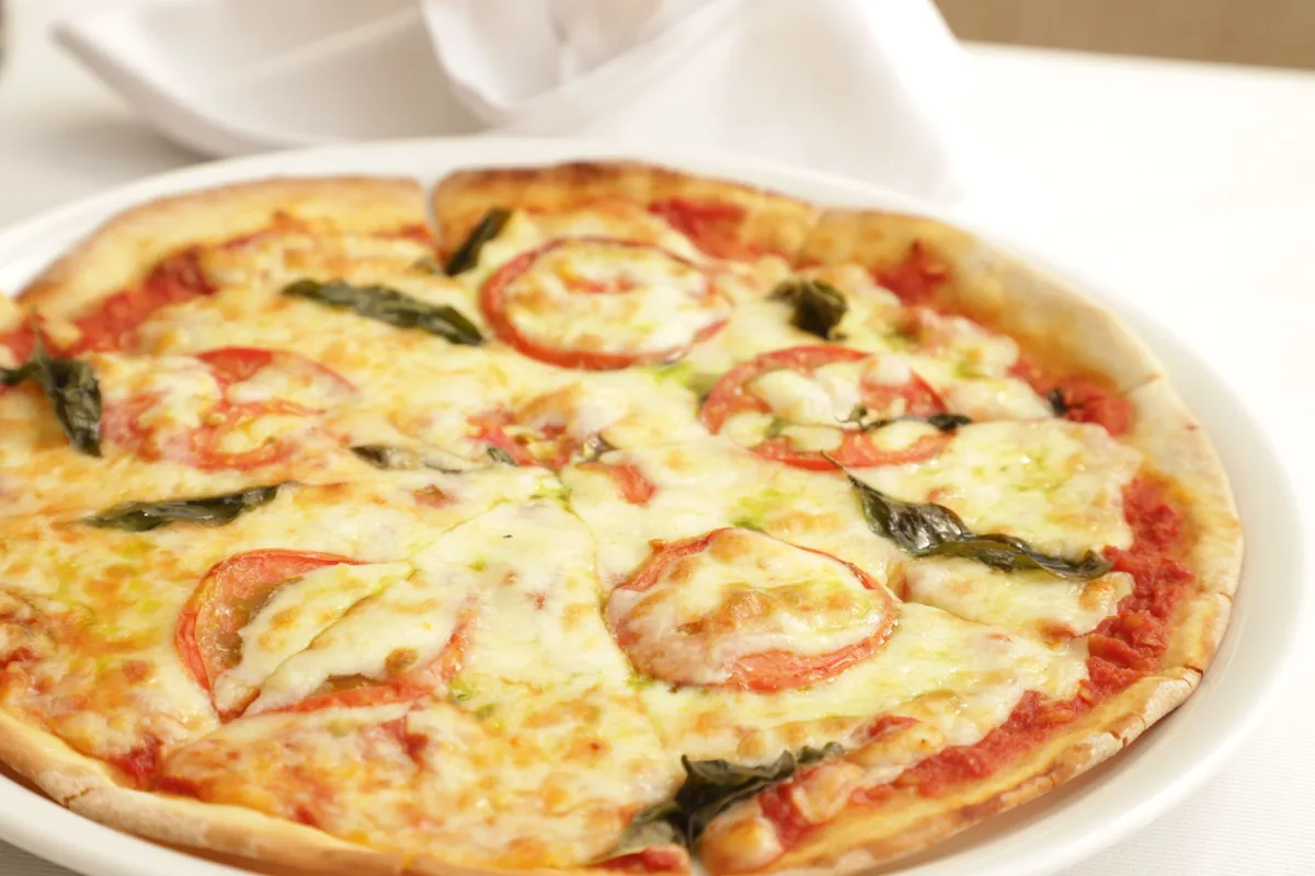 A margherita pizza with fresh mozzarella and basil leaves