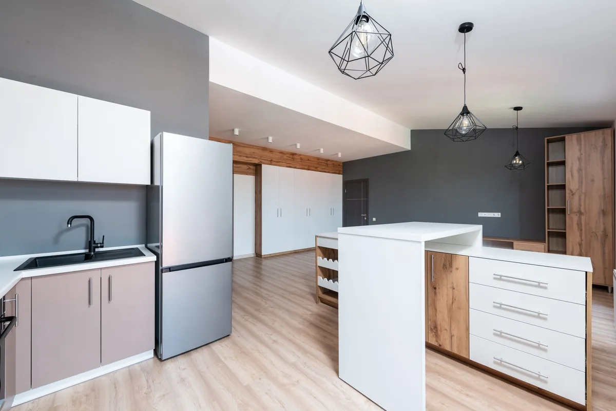 A modern kitchen with a tall steel refrigerator