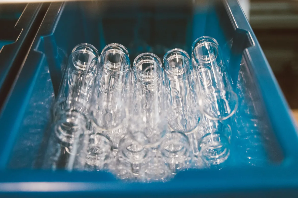 Rows of clear glass vials in a blue tray