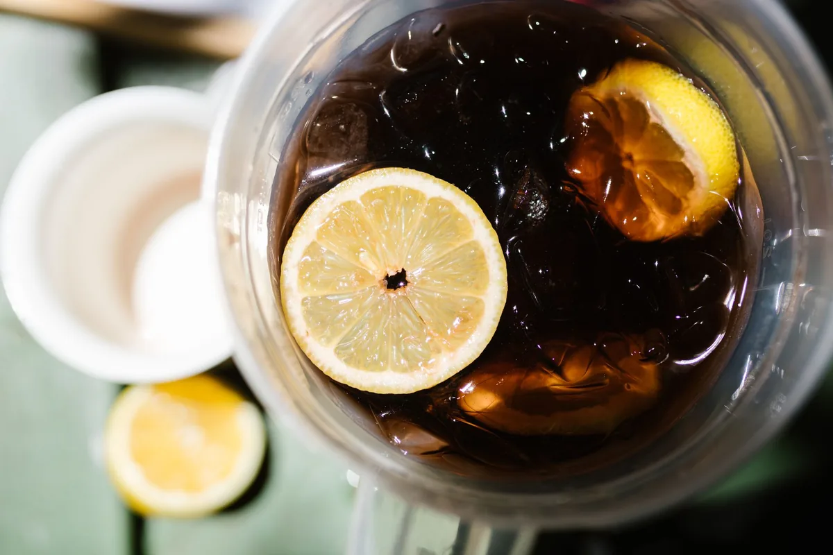 A glass of iced tea with lemon slices