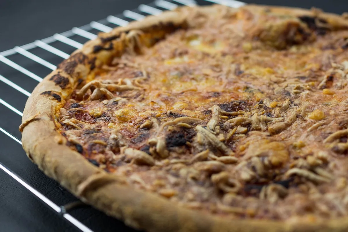 A pizza baking inside a home oven