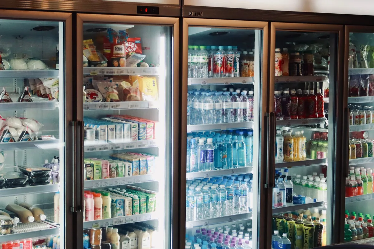 A row of glass-door coolers stocked with drinks