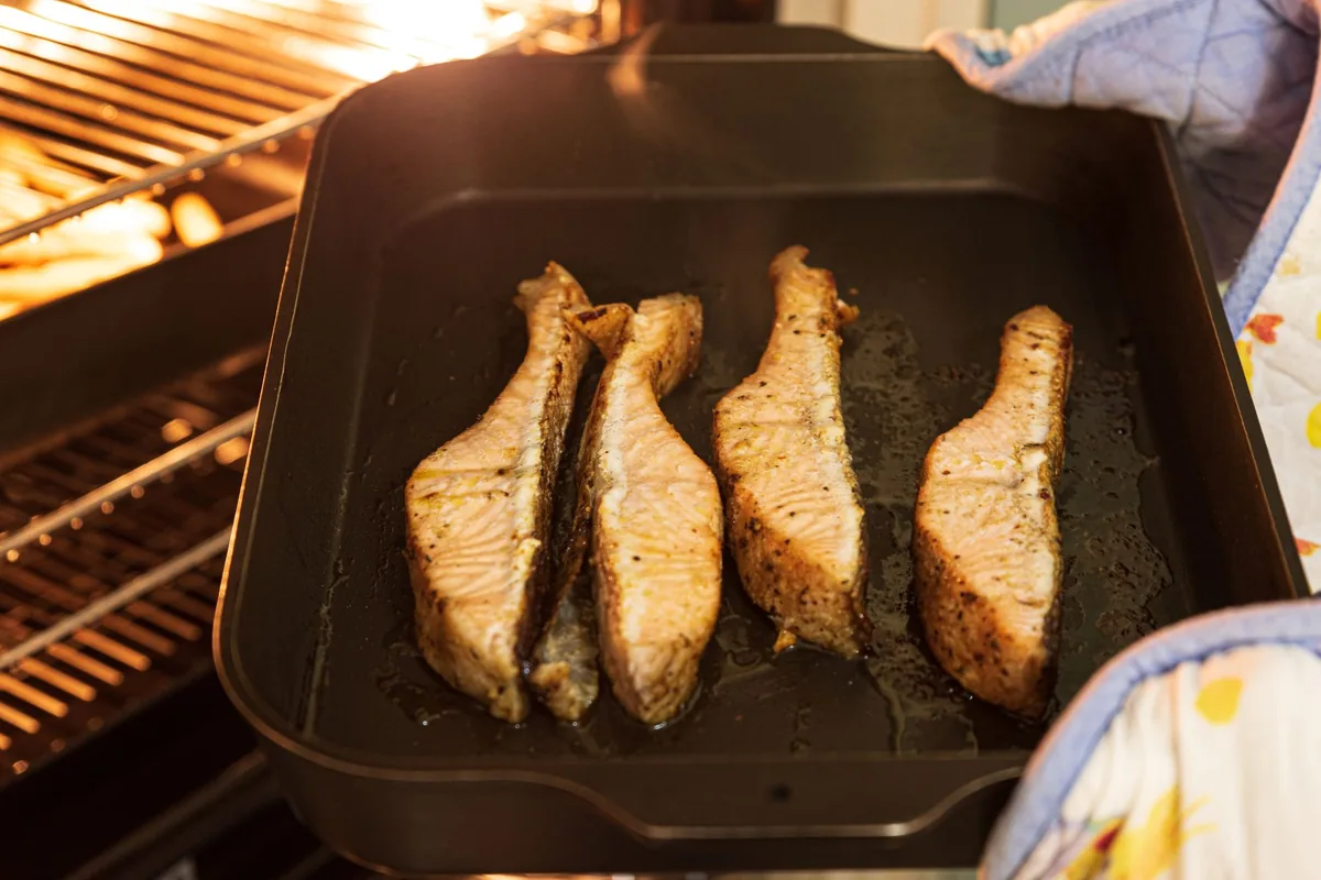 Fish fillets in a pan inside an oven