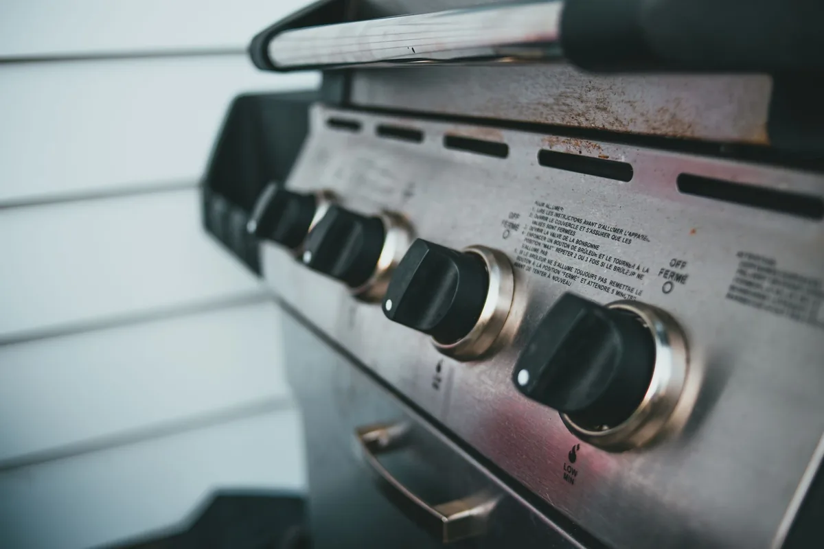 A stainless steel grill station on a patio