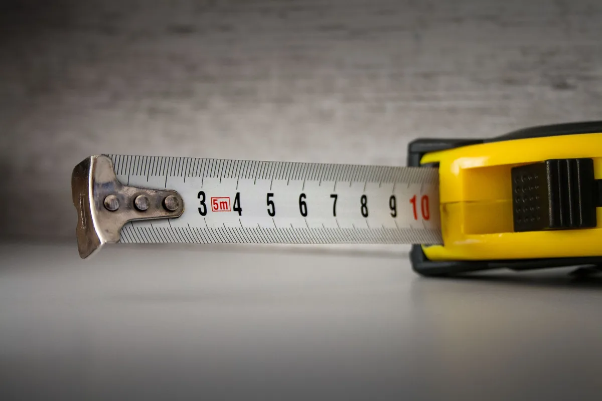 A tape measure pulled out across a kitchen worktop