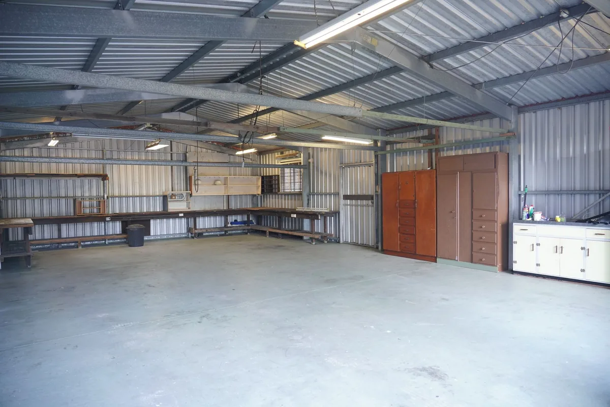 A tidy garage interior with metal shelving units along a plain wall