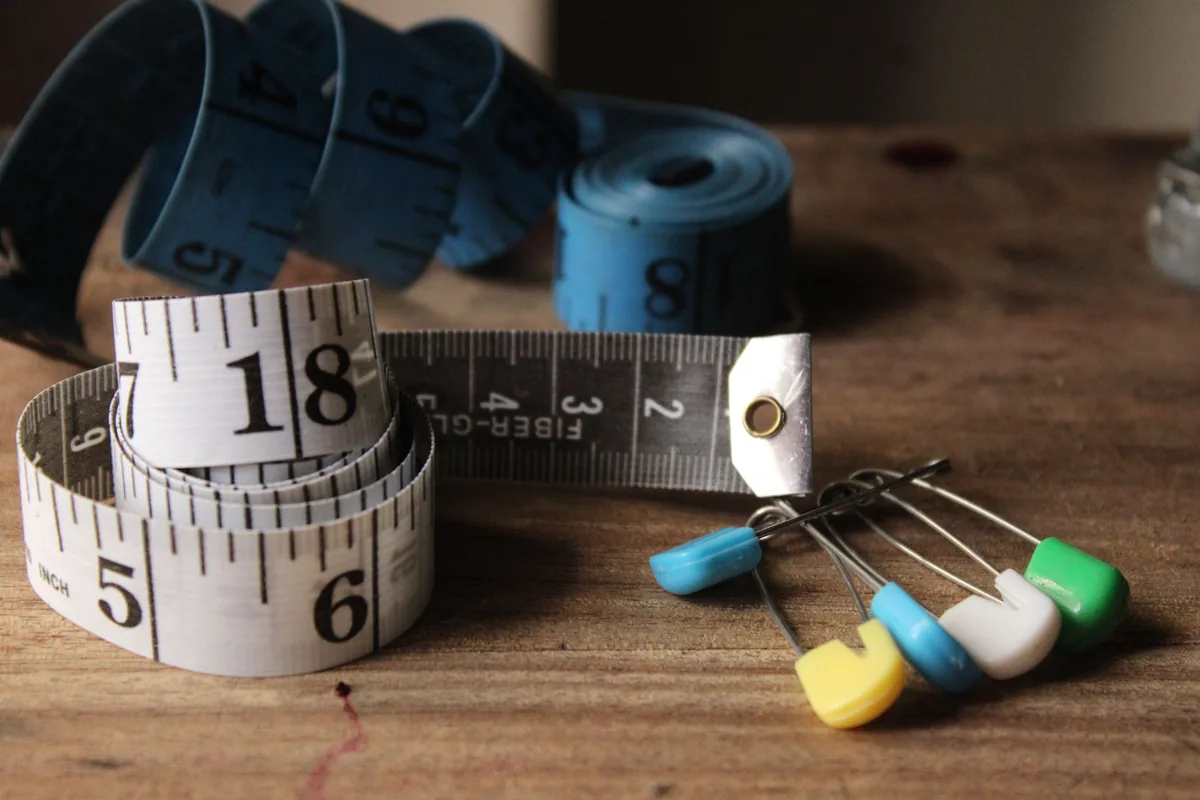 A coiled tape measure on a wooden table