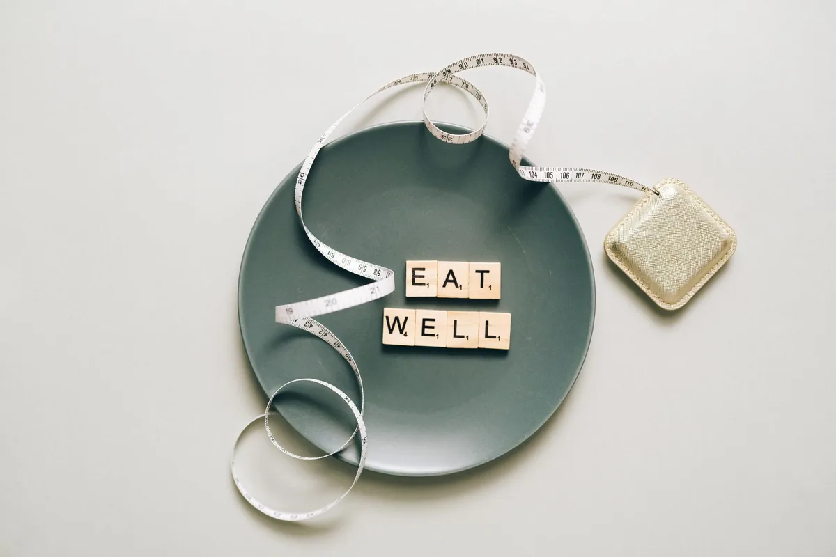 A plate with letter tiles and a tape measure