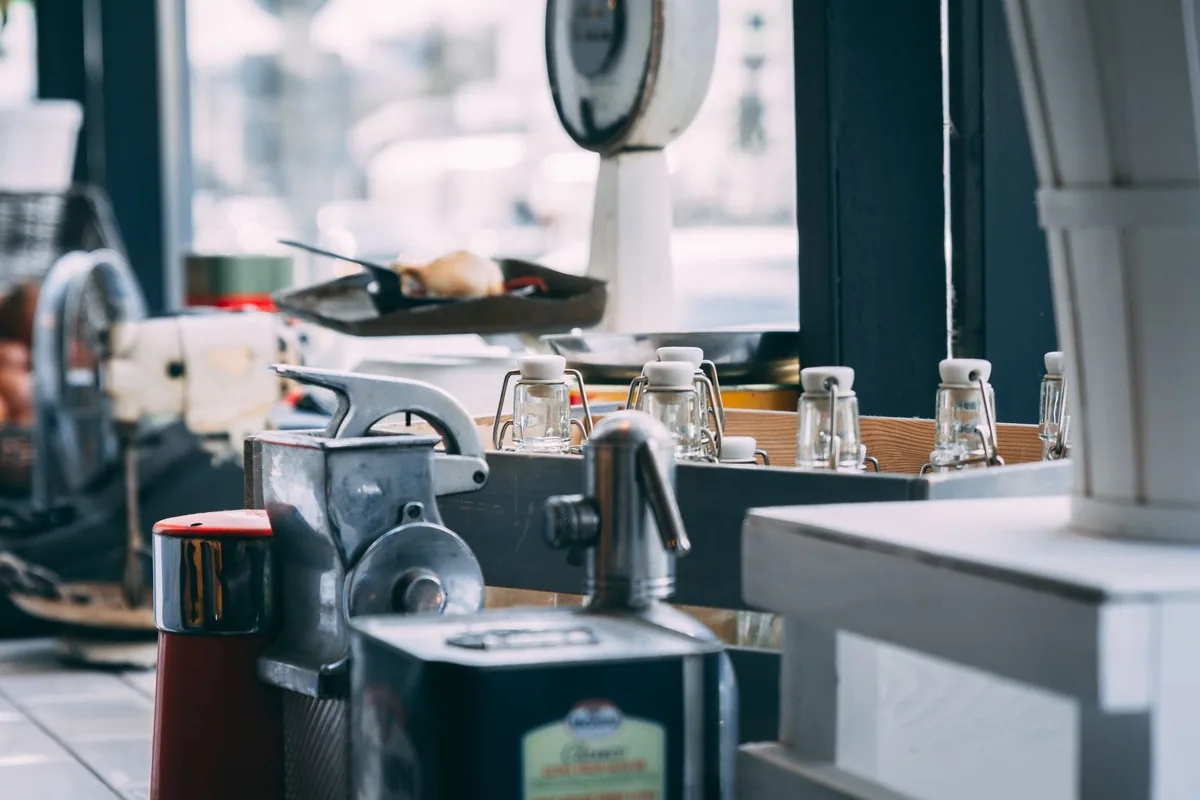 Kitchen machines lined up on a counter in a busy kitchen
