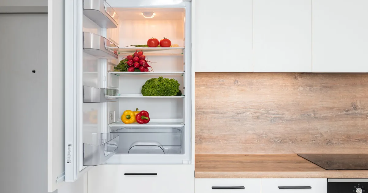 An open refrigerator in a white kitchen