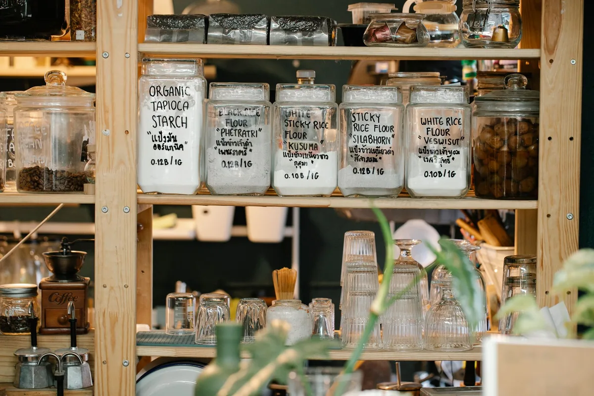 Bright pantry shelving holding glass jars and containers in tidy rows