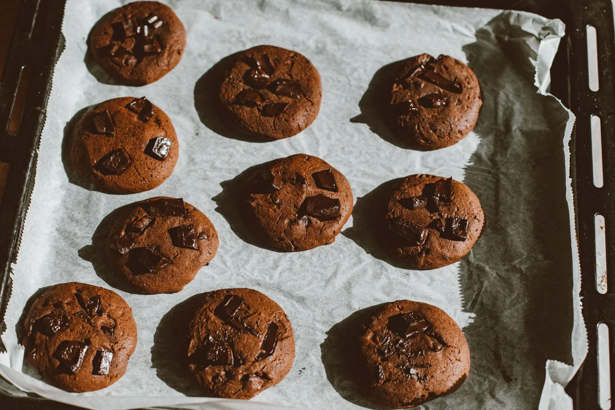 Chocolate cookies on a parchment-lined baking tray