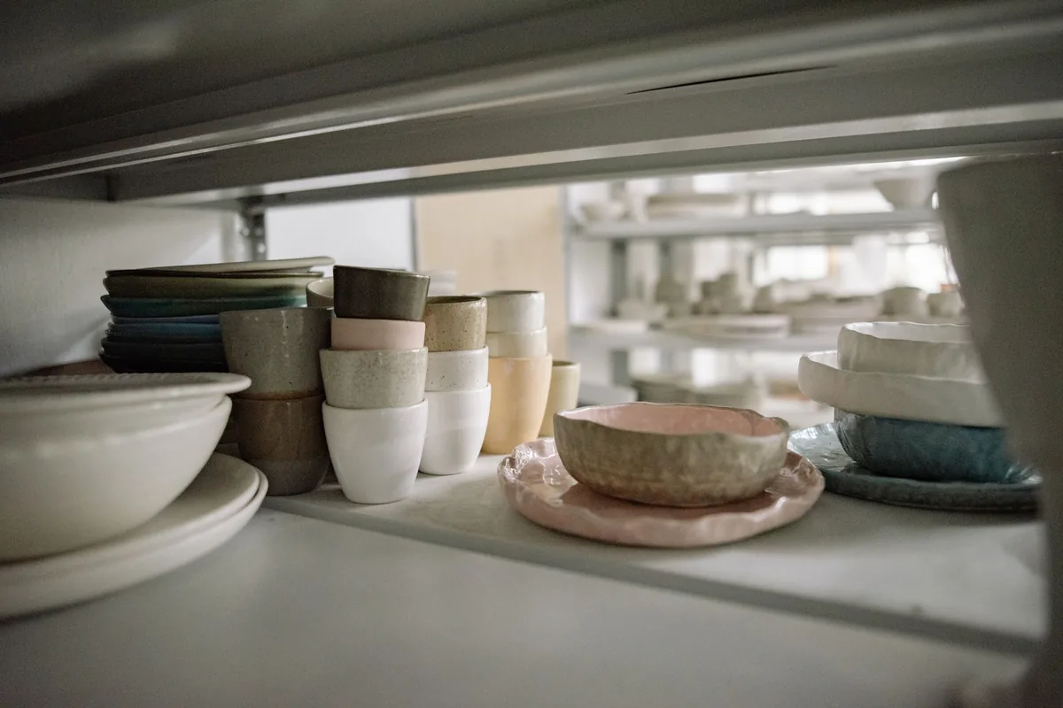 Clean bowls and cups grouped on a light kitchen worktop