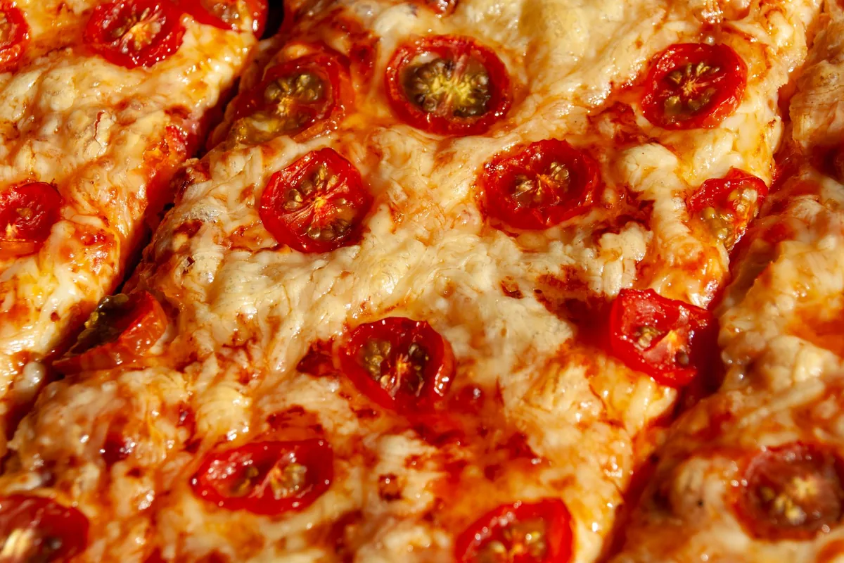 Close-up of a square corner slice of deep-dish pizza