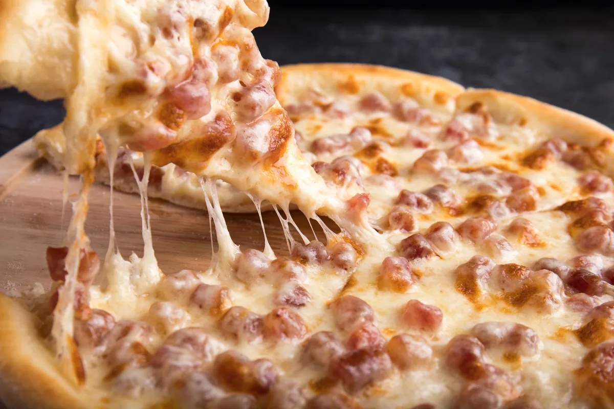 Close view of browned, melted cheese on a pizza