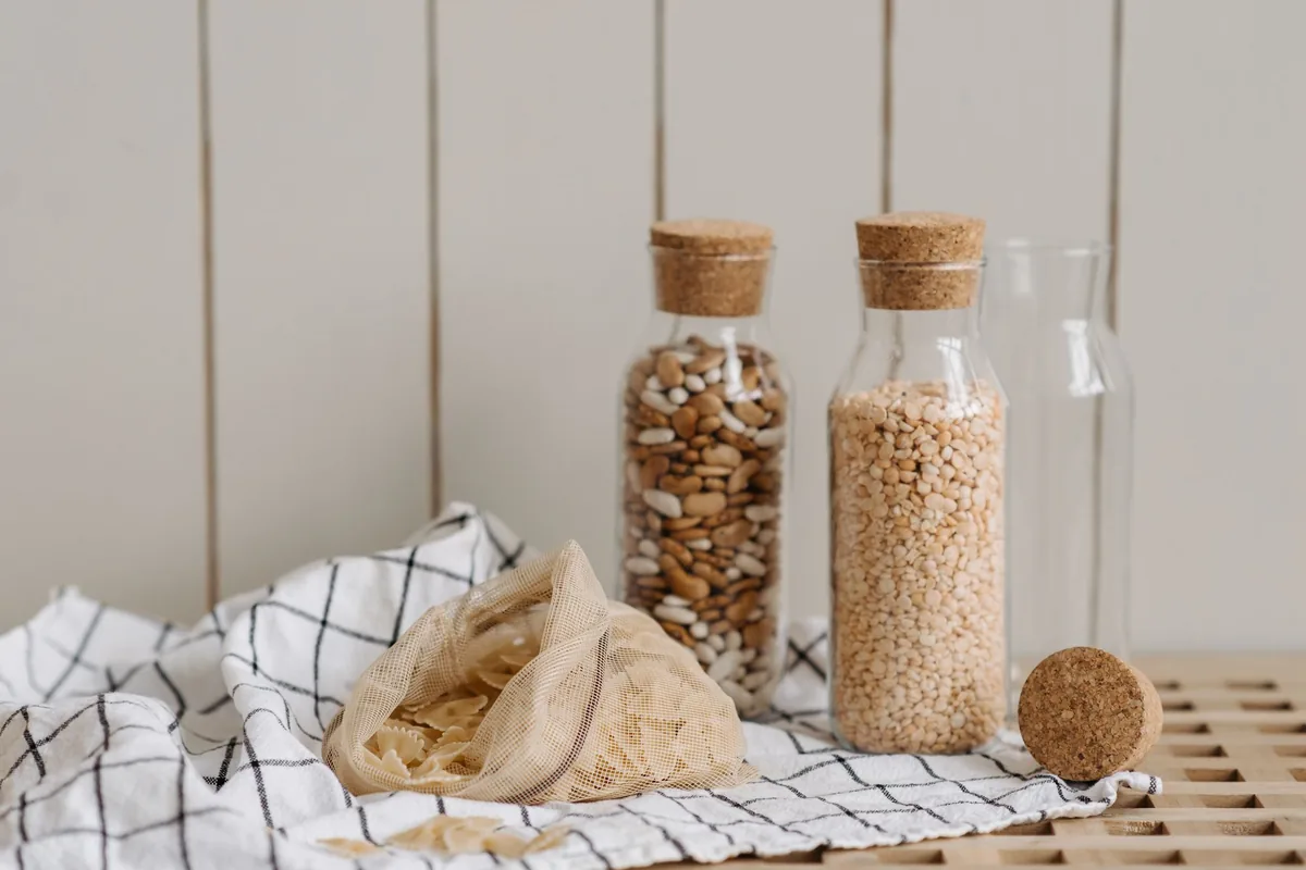 Cork-topped jars of nuts and grains on a cloth