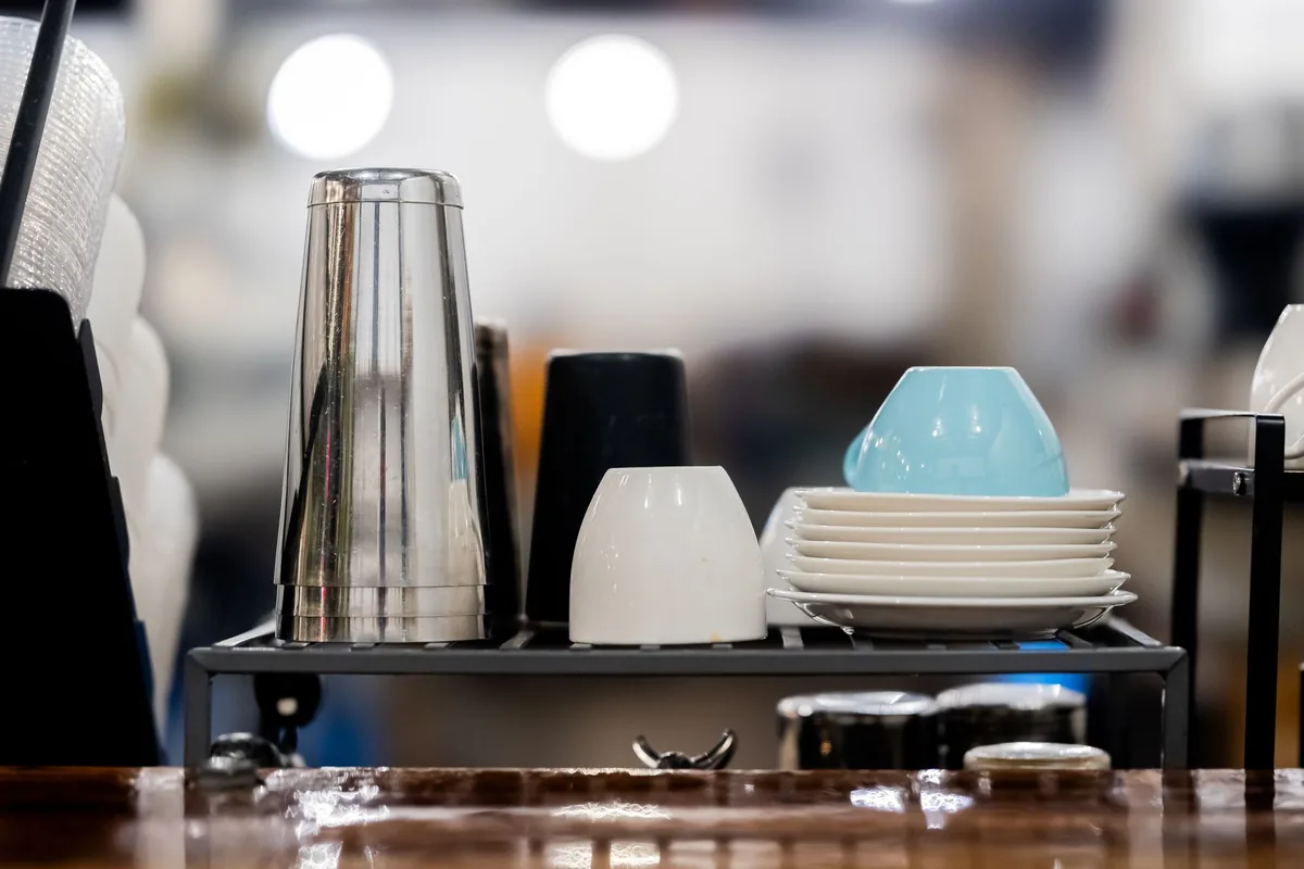 Cups and glasses stacked on a café counter