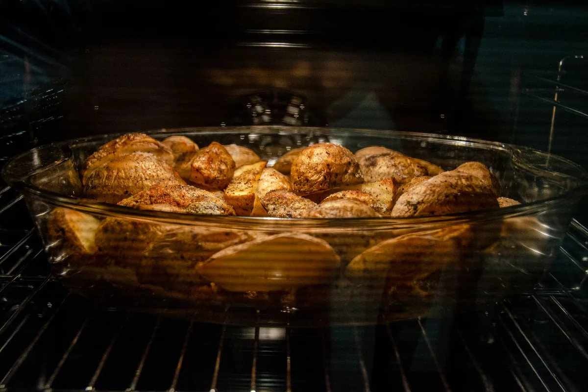 Food baking behind a lit oven door window