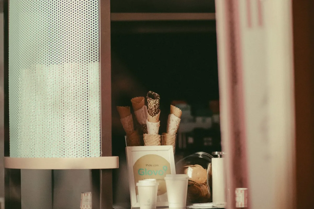 Gelato tubs with serving spades in a display case