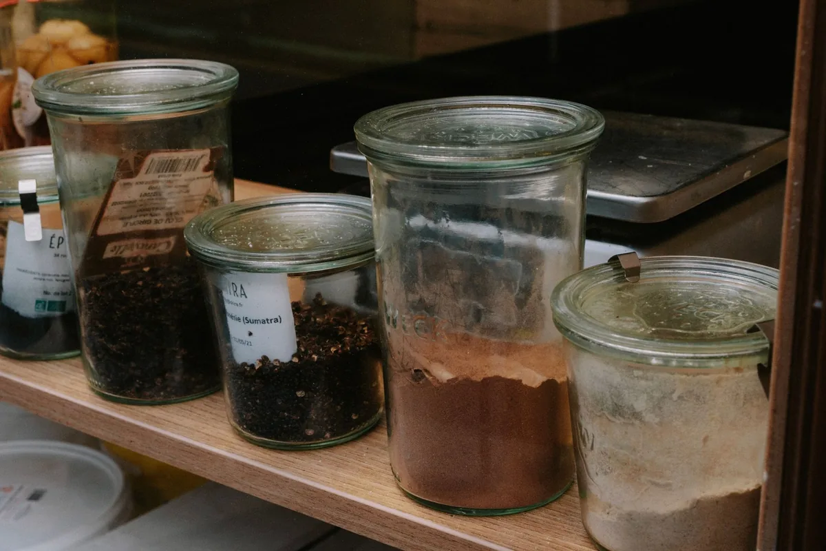 Glass jars of dried goods on a wooden counter
