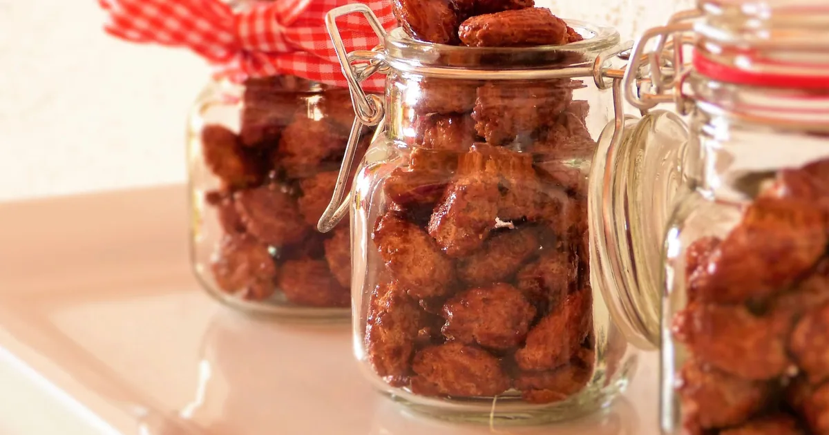 Glass jars of roasted almonds on a kitchen counter