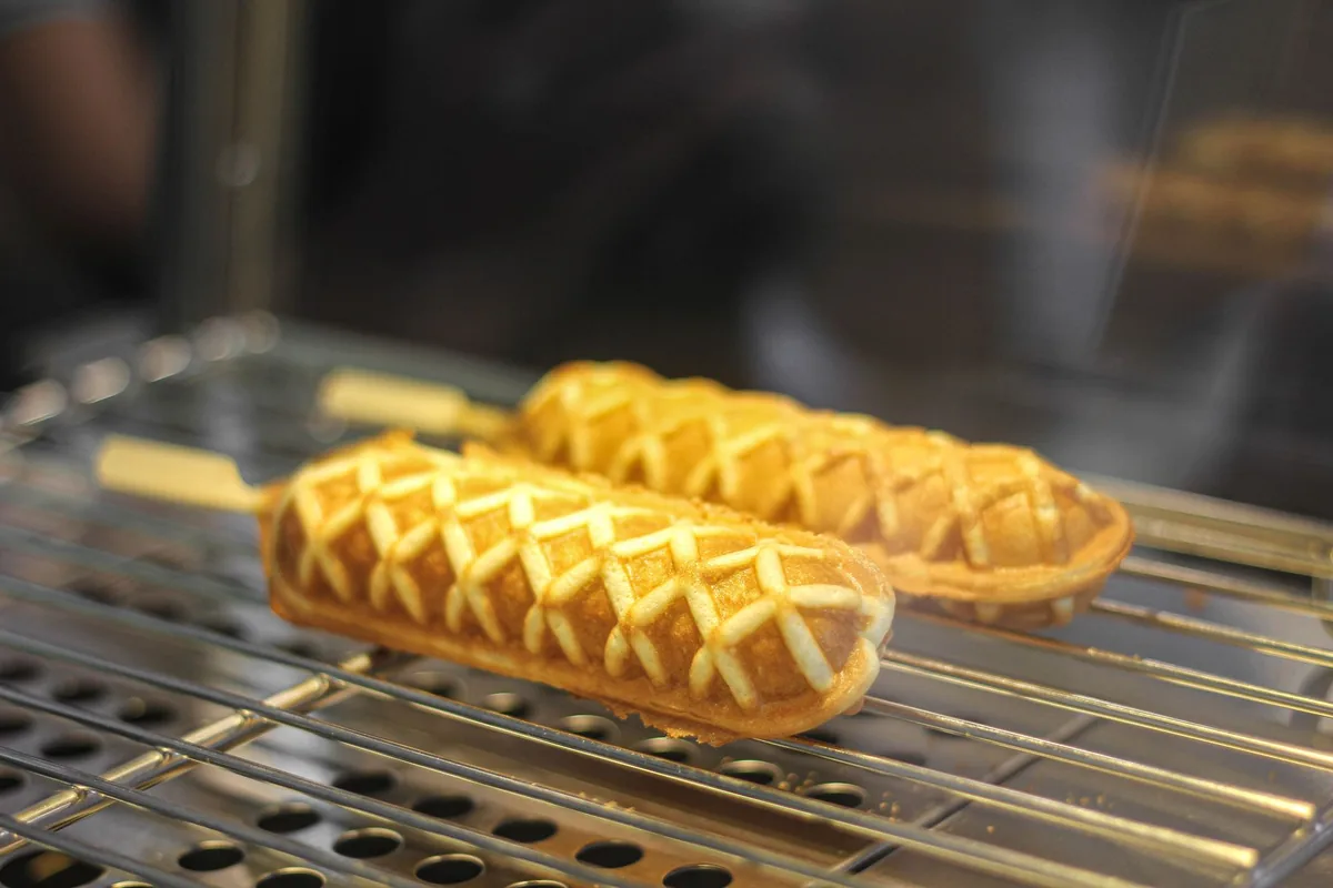 Golden waffle sticks cooling on a metal rack