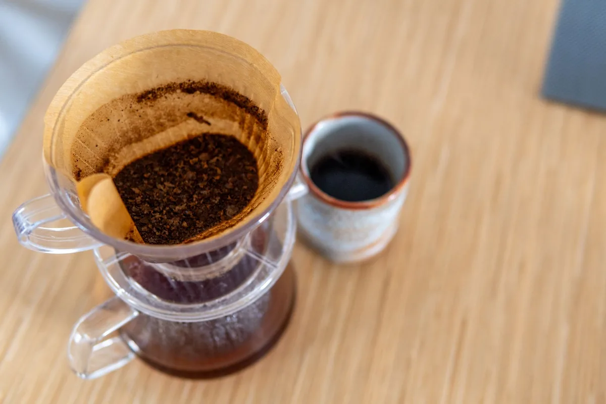 Hot water being poured over coffee grounds in a paper filter