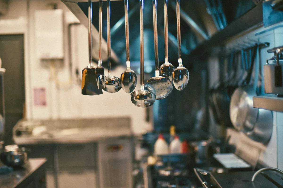 Ladles hanging above a stainless commercial range