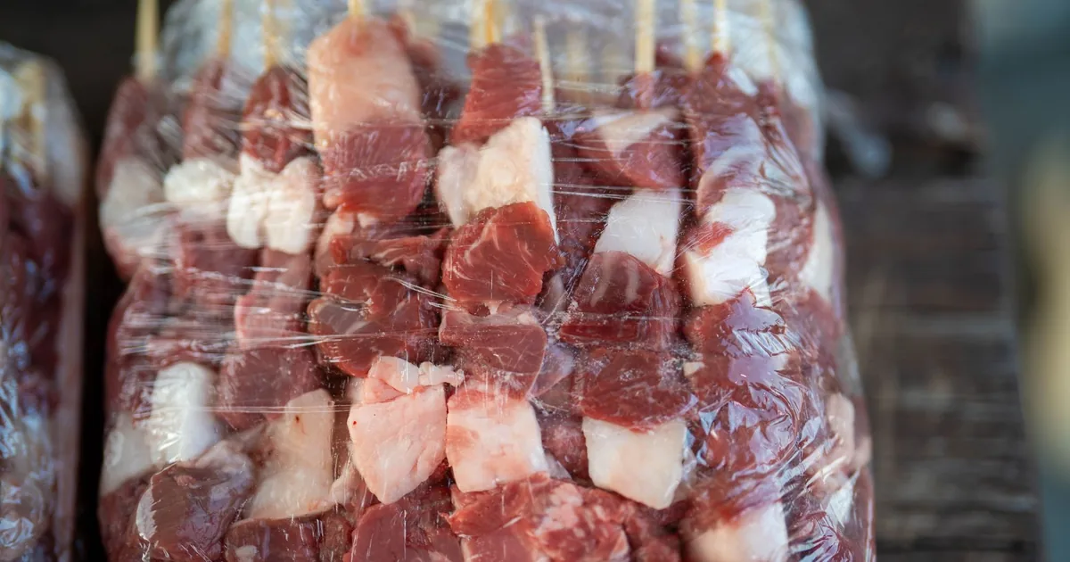 Meat skewers wrapped tightly in clear film