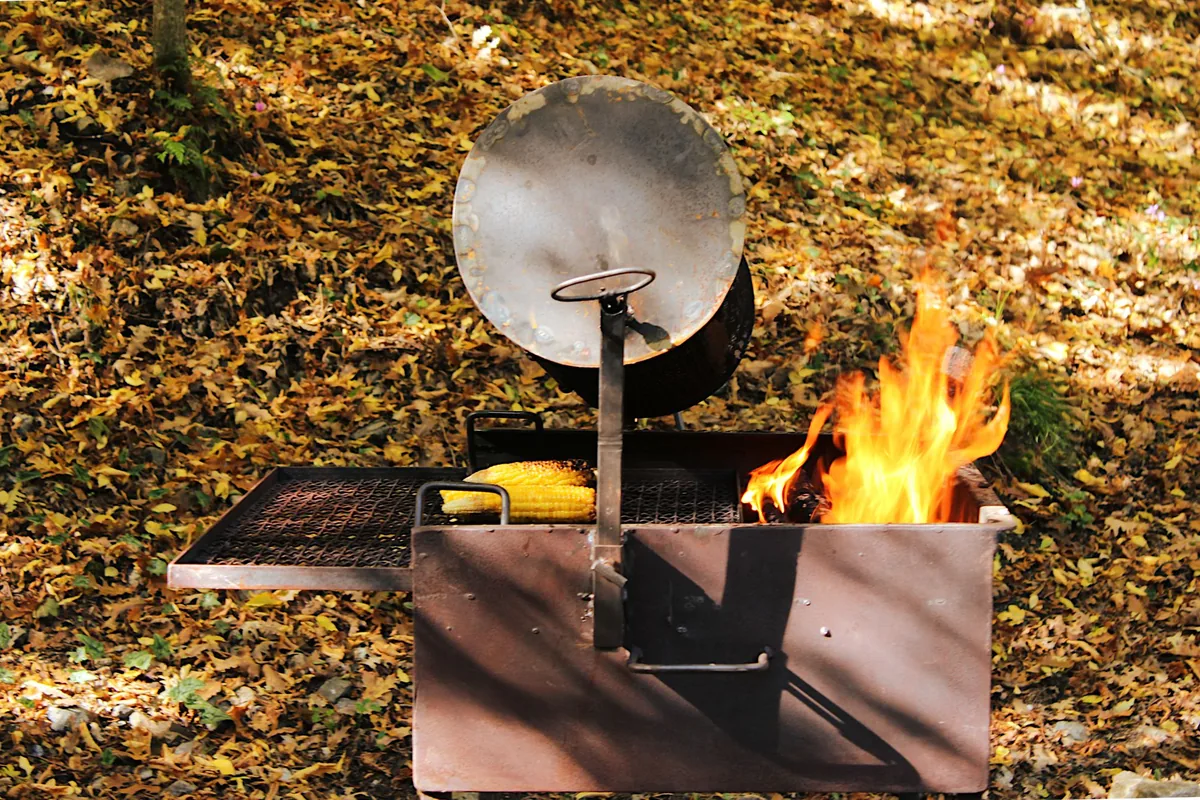 A portable fire grill burning outdoors