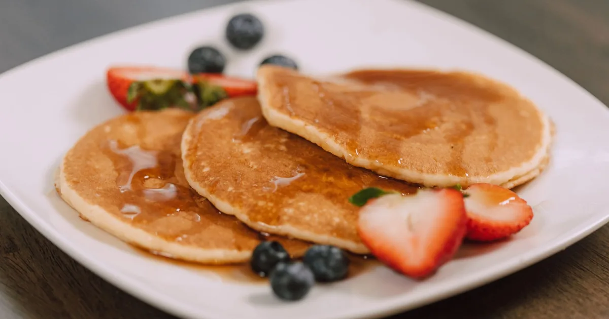 Pancakes with berries and syrup on a plate