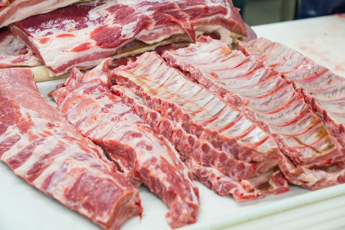Racks of raw pork ribs on a white counter