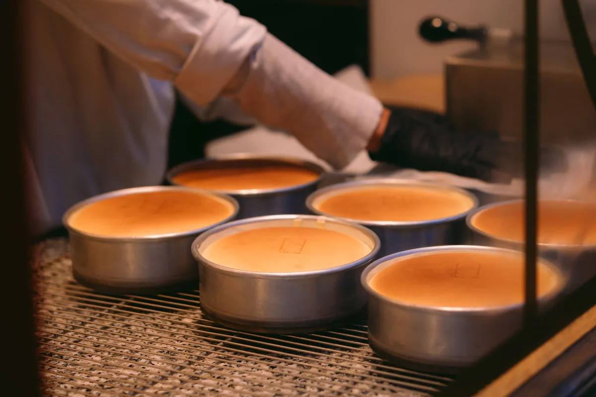 Round cake tins of batter baking on an oven rack