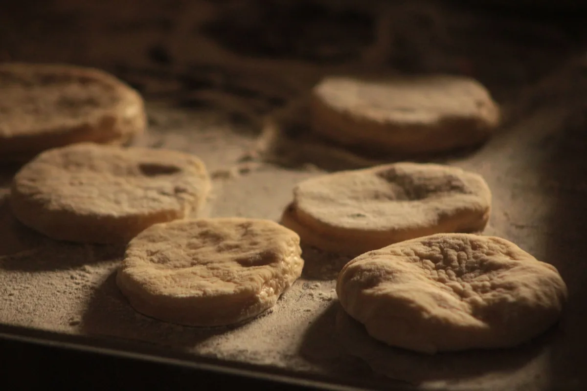 Rounds of dough resting on a floured tray