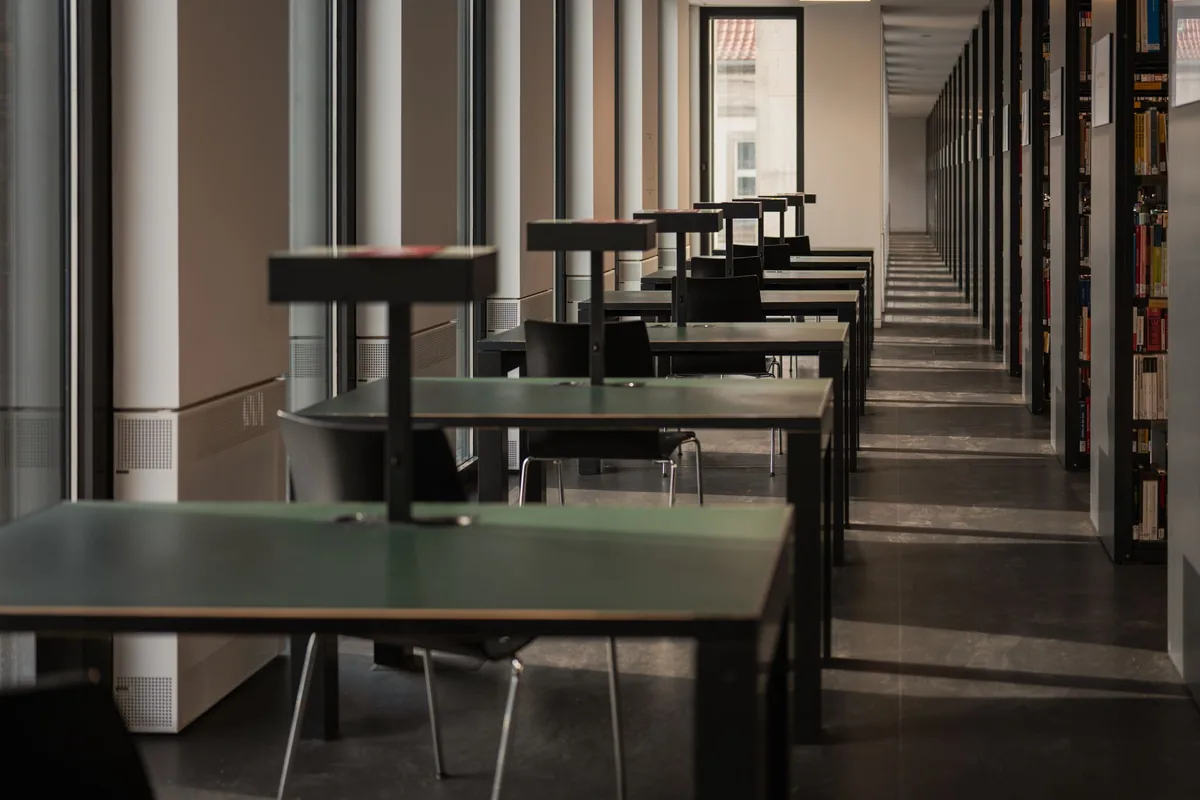Rows of empty tables and chairs in a quiet study room