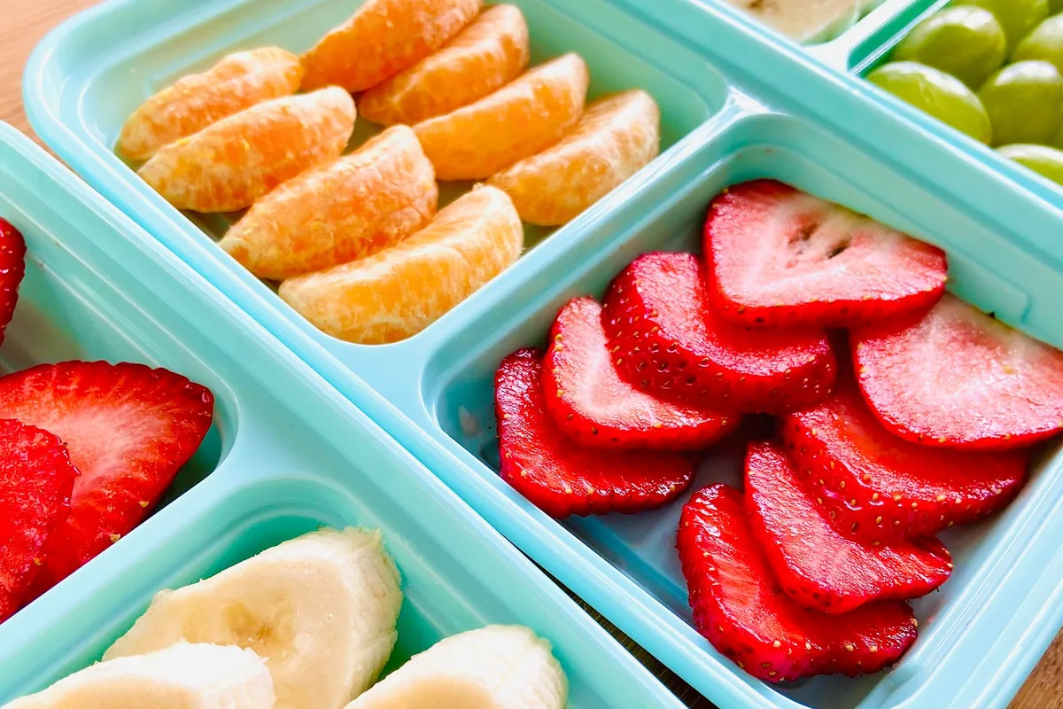 Orange segments, strawberries and banana in a divided tray