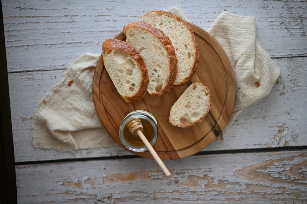 Sliced bread on a round wooden board
